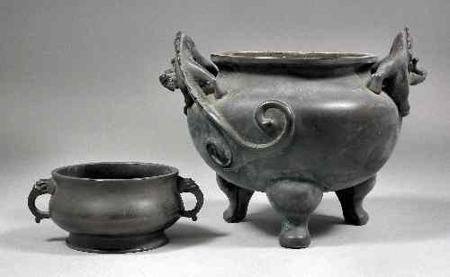 Appraisal: A small Chinese bronze two-handled censer with circular baluster shaped