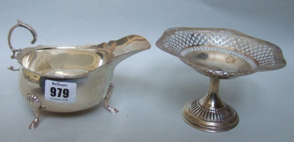 Appraisal: A silver sauceboat with a shaped rim scrolling handle and