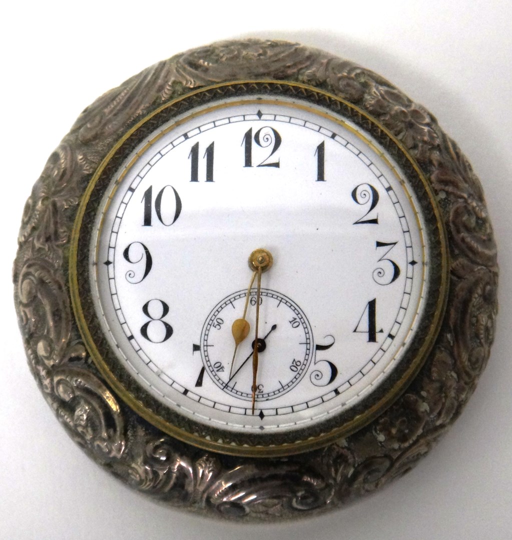 Appraisal: A late Victorian silver mounted circular travelling clock the unsigned