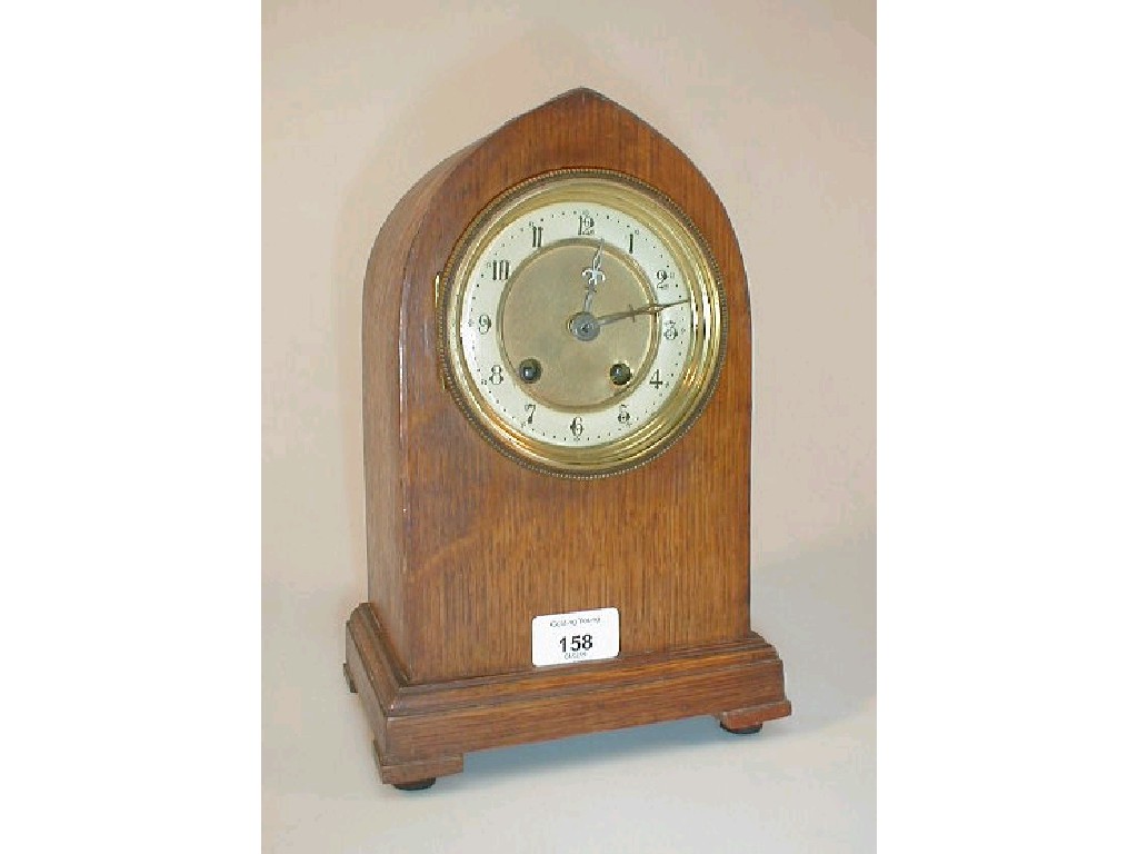 Appraisal: An Edwardian oak lancet mantel clock with eight day movement