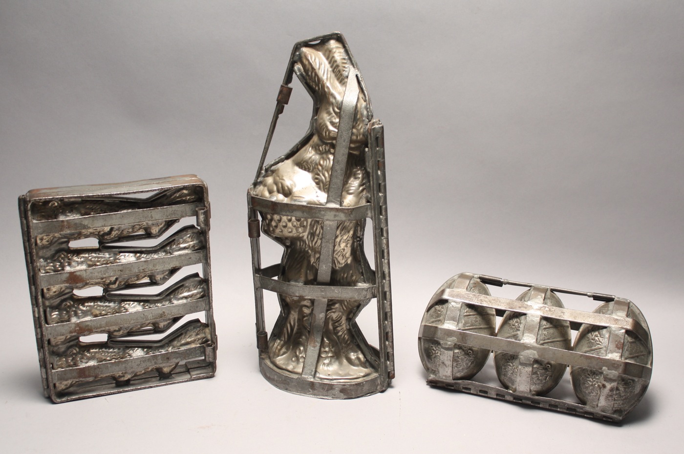 Appraisal: THREE WHITE METAL CHOCOLATE MOLDS Late th Early th CenturyStanding