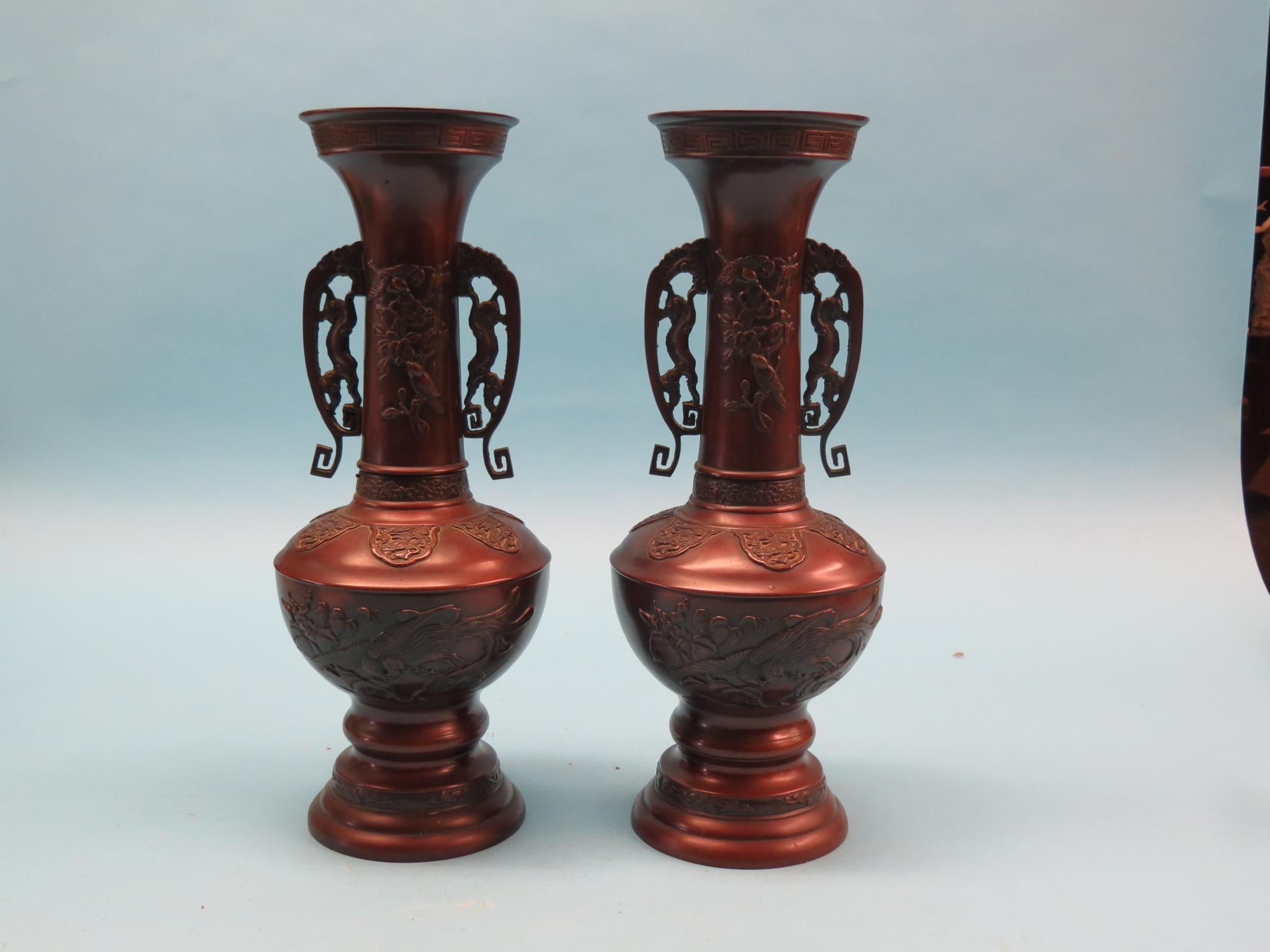 Appraisal: A pair of Japanese bronze vases each with twin dragon