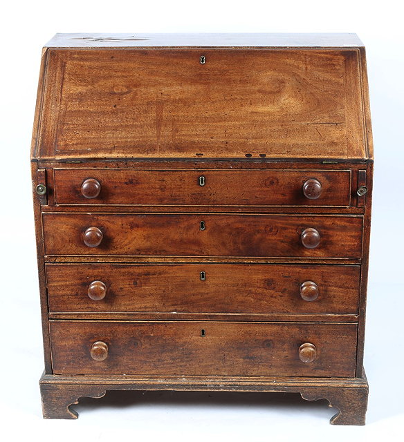 Appraisal: A GEORGIAN PROVINCIAL MAHOGANY BUREAU with fitted interior enclosed by