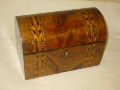 Appraisal: A VICTORIAN WALNUT TEA CADDY of oblong form with domed