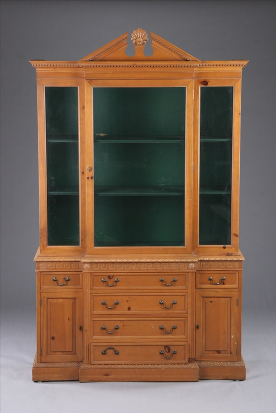 Appraisal: GEORGIAN STYLE PINE GLAZED-DOOR BREAKFRONT BOOKCASE th century Shell-centered broken