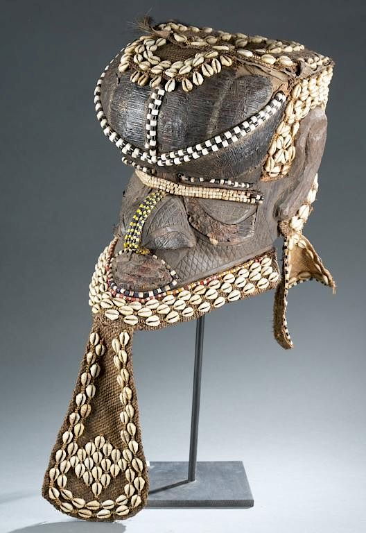 Appraisal: Helmet mask A helmet mask embellished with cowries and a