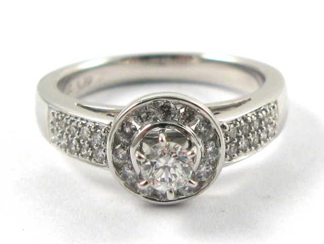 Appraisal: DIAMOND AND FOURTEEN KARAT GOLD RING centering a round brilliant-cut