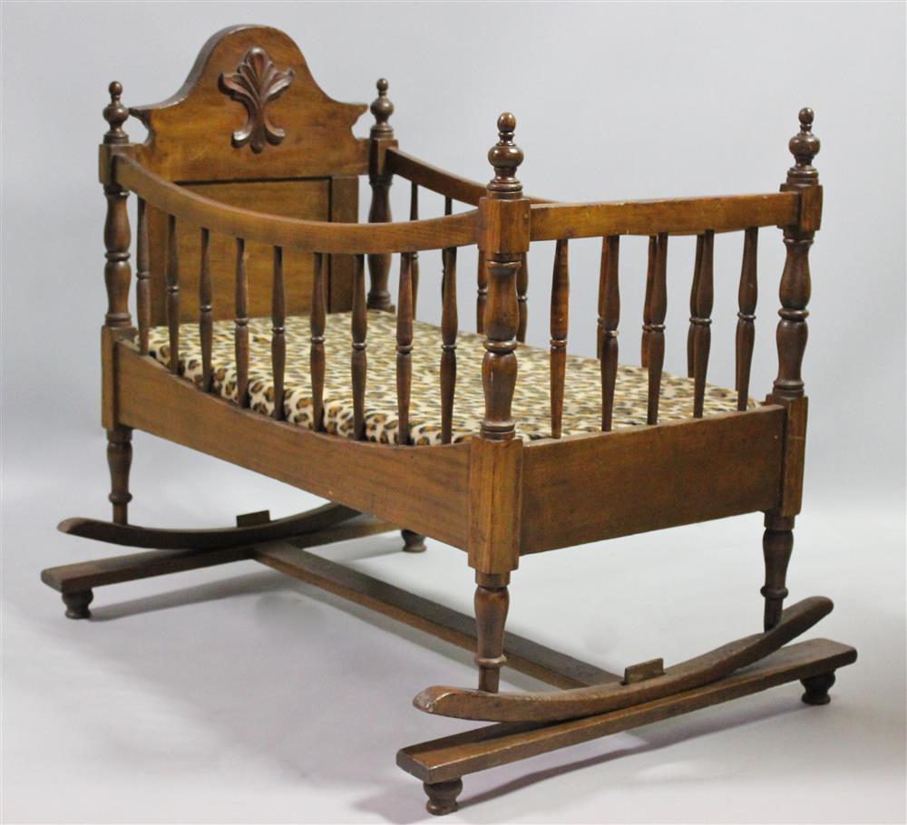 Appraisal: ROCKING WALNUT BASSINET CRADLE WITH LEOPARD PRINT MATTRESS with arched