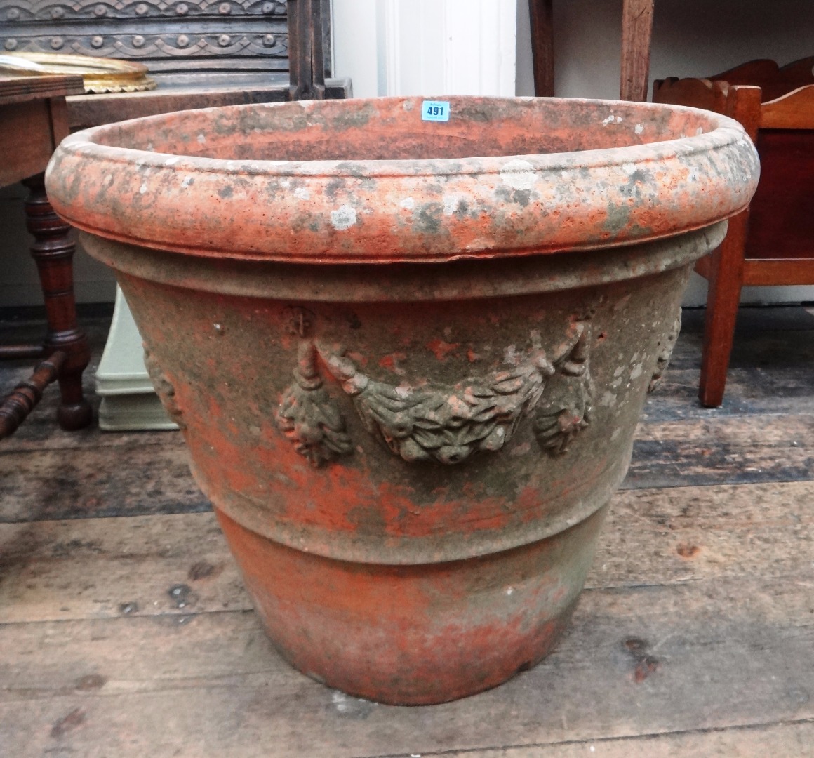 Appraisal: A terracotta terrace urn of circular tapering form the sides