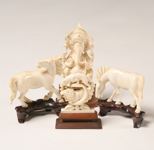 Appraisal: Asian ivory carved figures including an elephant saber tooth tiger