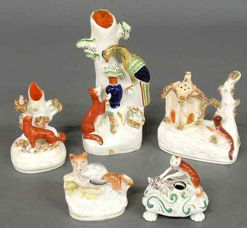 Appraisal: Five Staffordshire fox figural groups c including a quill holder