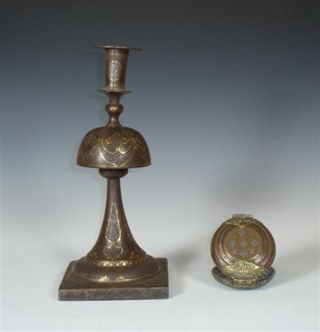 Appraisal: A Persian inlaid and engraved table candlestick the sconce with