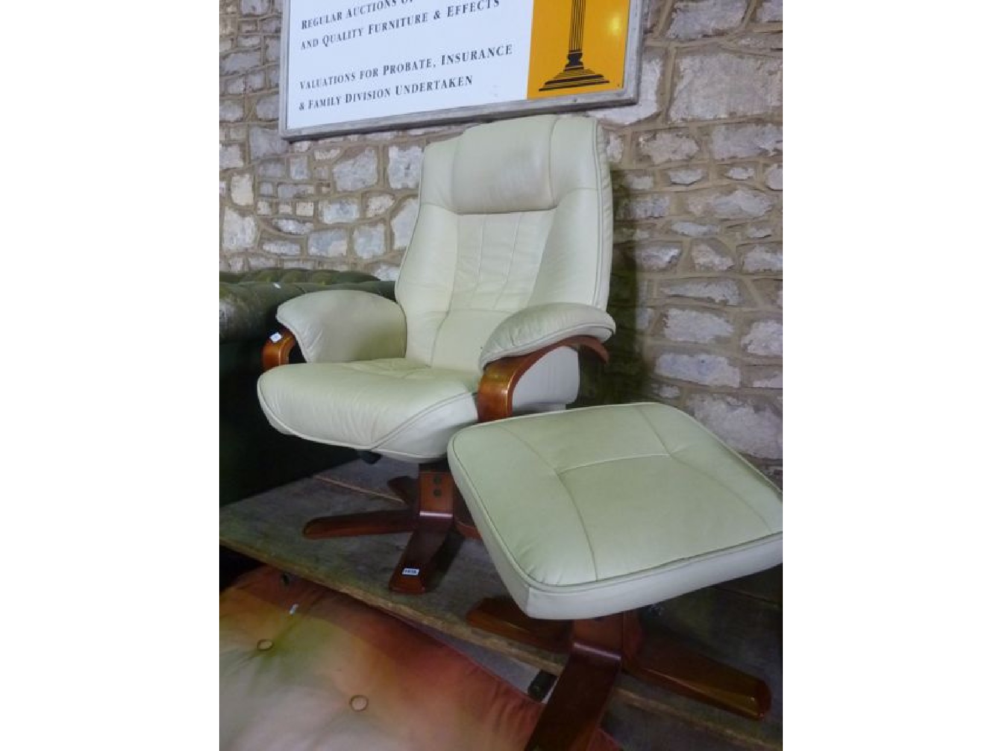 Appraisal: A contemporary cream leather upholstered swivel and adjustable lounge chair