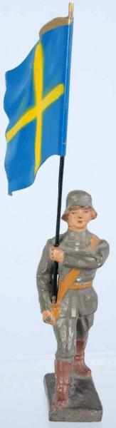 Appraisal: Lineol cm Swedish Flag-Bearer Tin flag with composition man Condition