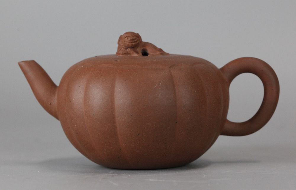 Appraisal: Chinese lobed yixing teapot cover surmounted by a lion in