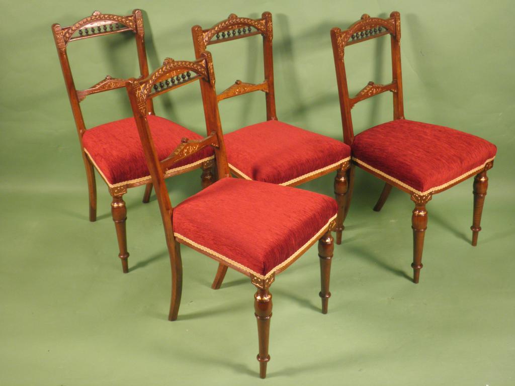 Appraisal: A set of four Victorian walnut and parcel gilt dining