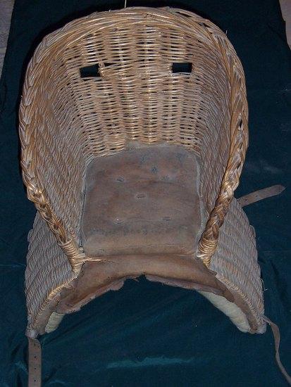 Appraisal: A wicker basket saddle with padded seat and a child's