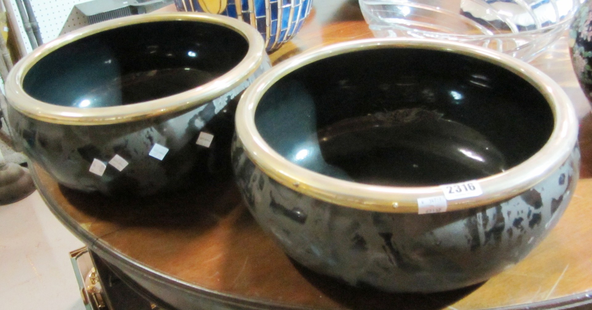 Appraisal: A pair of black ceramic bowls with metal rings