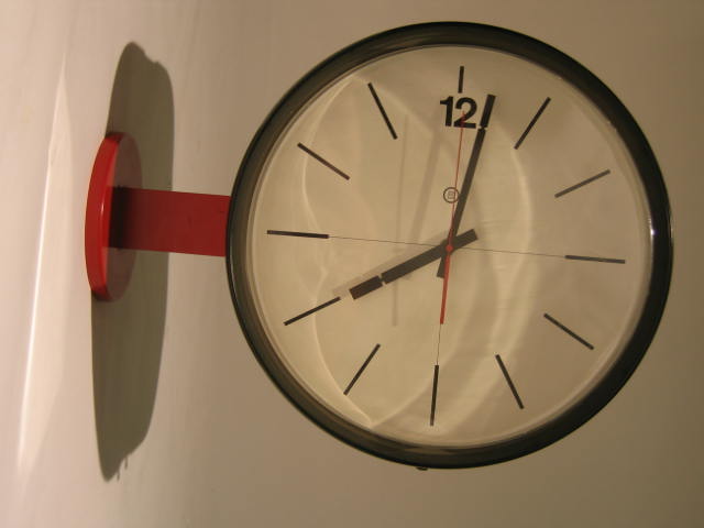 Appraisal: PETER PEPPER Red and black enameled metal wall clock l