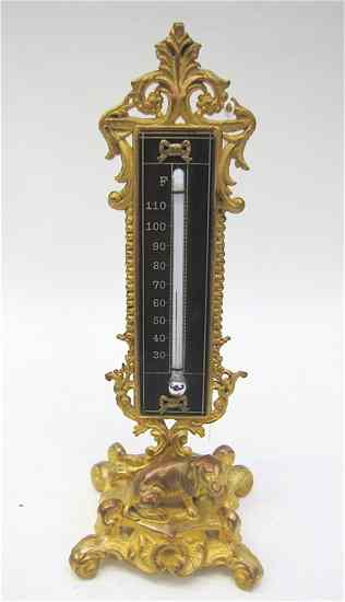 Appraisal: GILT METAL DESK THERMOMETER having a pedestal base with dog