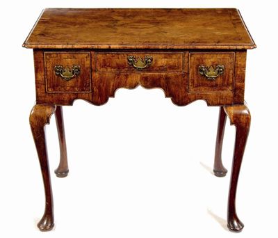 Appraisal: A walnut lowboy in George I style cross and feather