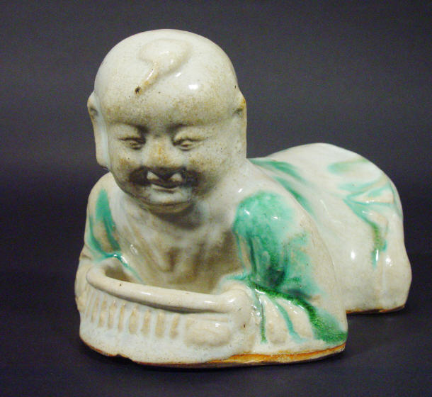 Appraisal: Oriental stoneware dish modelled as a figure crouching over a