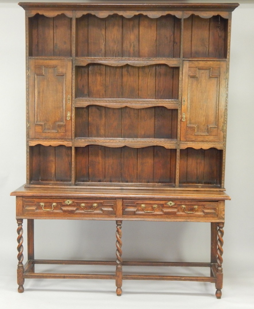 Appraisal: A thC oak dresser in early thC style with combination