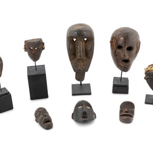 Appraisal: A Group of Eight Miniature Ethnographic Carved Masks Five with