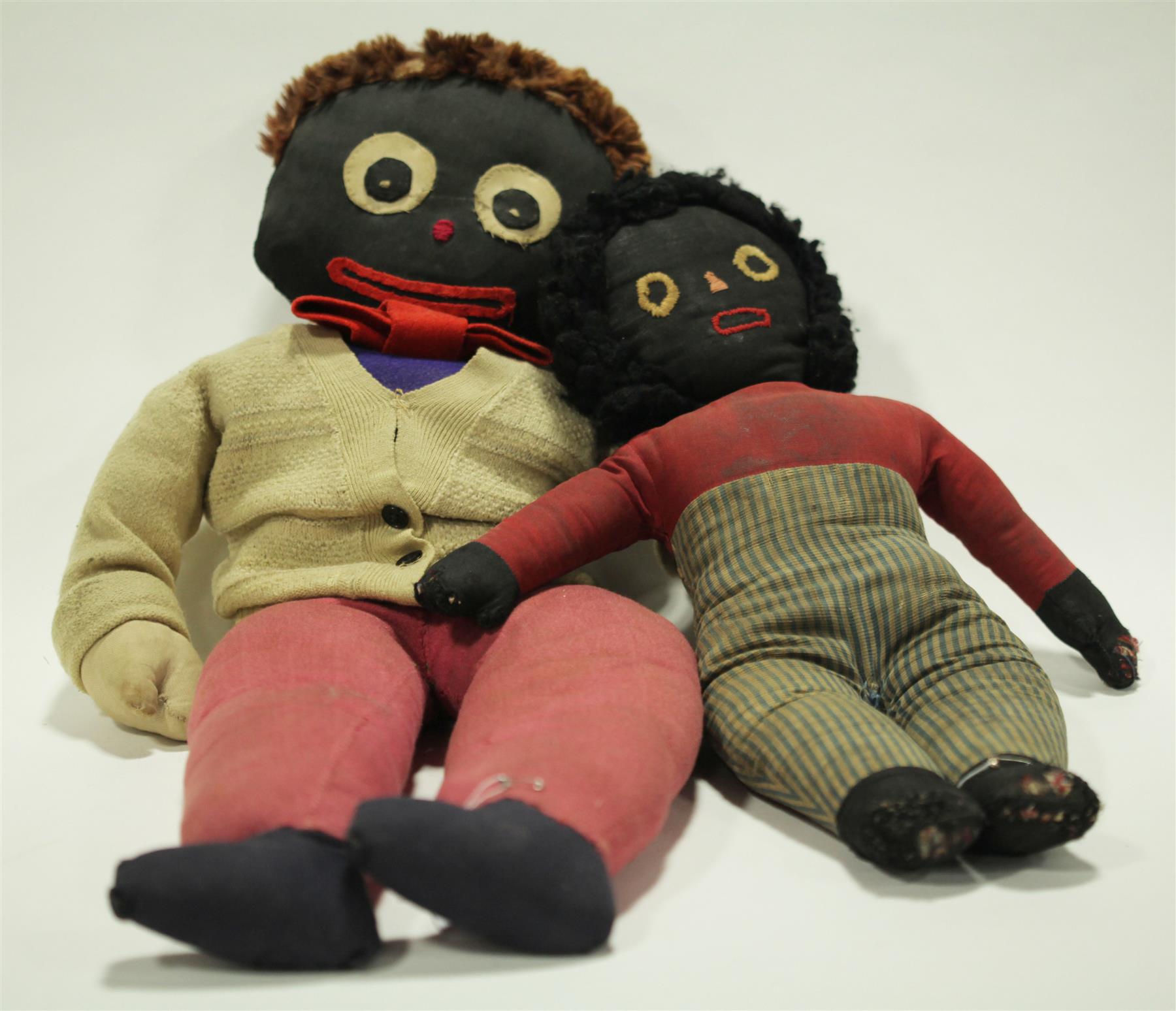 Appraisal: TWO GOLLIWOG STYLE DOLLS Early th century One unusually large