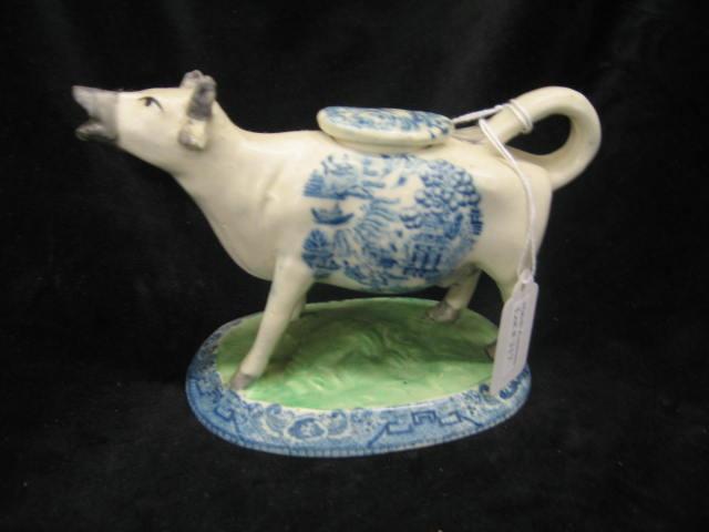 Appraisal: Staffordshire Pottery Figural Cow Creamer blue willow trim tall long