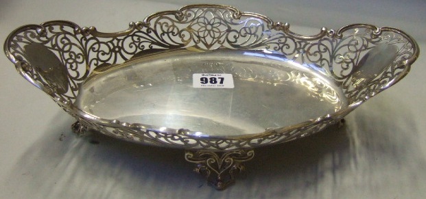 Appraisal: A silver shaped oval sweetmeat stand with scroll pierced decoration