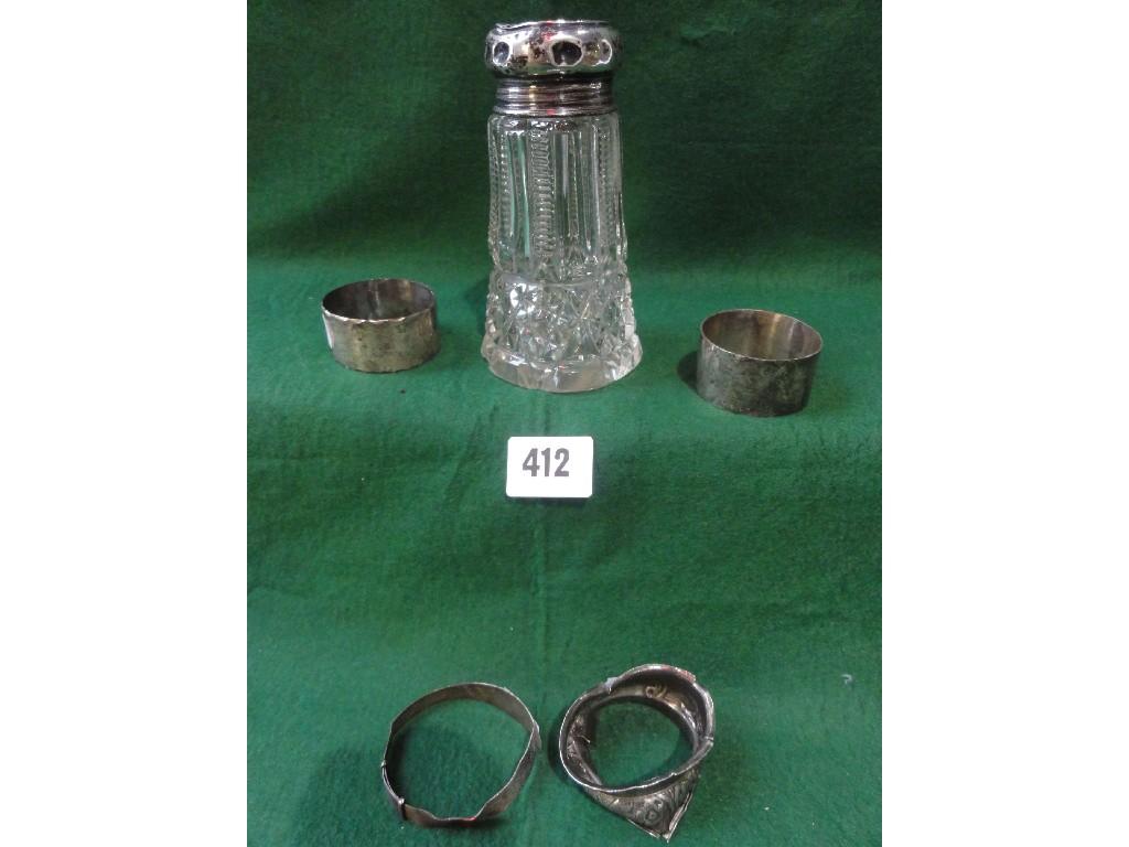 Appraisal: A silver capped glass sugar shaker three napkin rings and