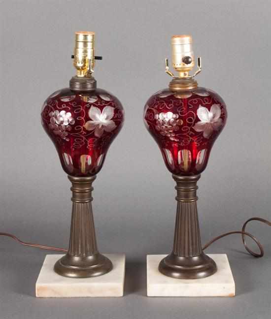 Appraisal: Pair of old reproduction Bohemian cranberry etched-to-clear glass lamps grape