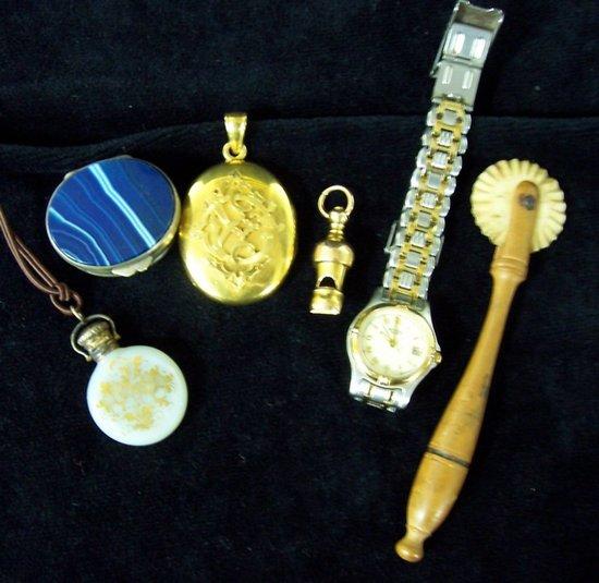 Appraisal: A Victorian oval locket applied a monogram a whistle an