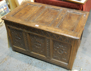 Appraisal: A carved oak panelled small coffer with hinged lid cm