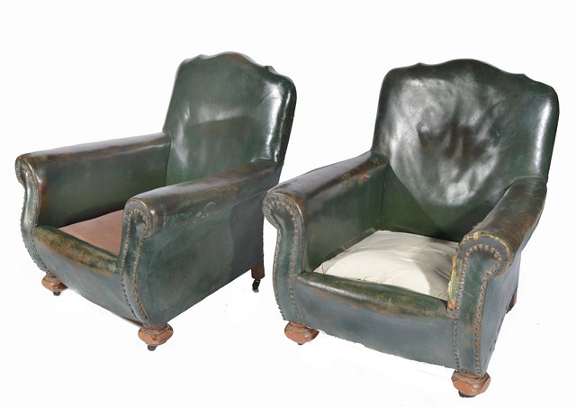 Appraisal: A PAIR OF EDWARDIAN LEATHER ARMCHAIRS with bun supports and