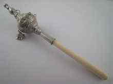 Appraisal: A French silver baby's rattle with bell whistle and ivory