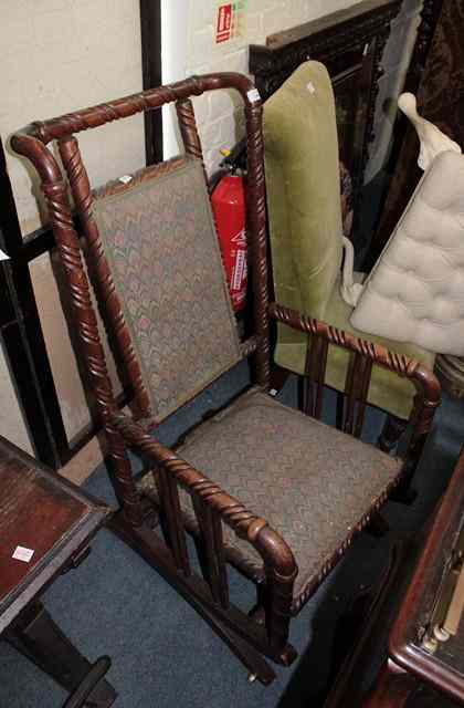 Appraisal: AN AMERICAN SPIRAL TURNED OAK FRAME ROCKING CHAIR with sprung