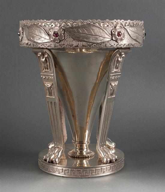 Appraisal: Classical style silvered metal champagne bucket stand and a classical