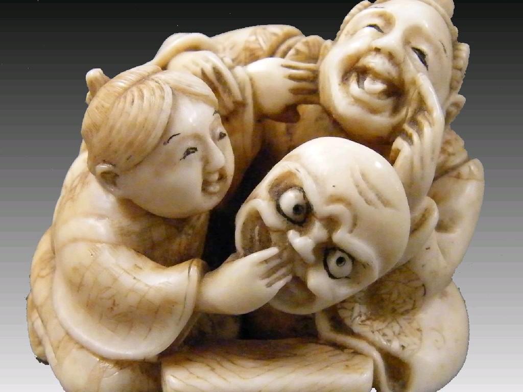 Appraisal: Japanese ivory netsuke modelled with two seated figures holding a