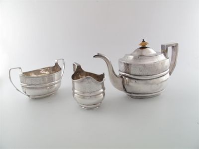 Appraisal: A George III three-piece tea service of rounded oblong form