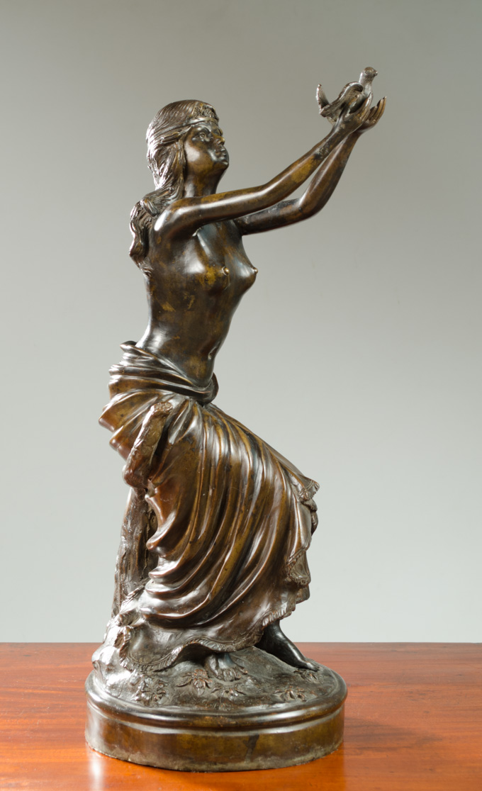 Appraisal: NEOCLASSIC BRONZE SCULPTURE of a semi-clad woman releasing a dove