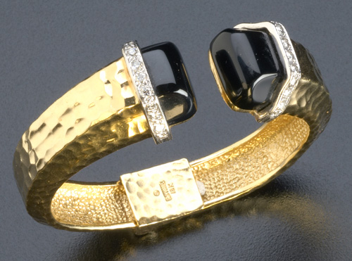 Appraisal: Robert Stone hinged bangle with onyx and diamond terminals in