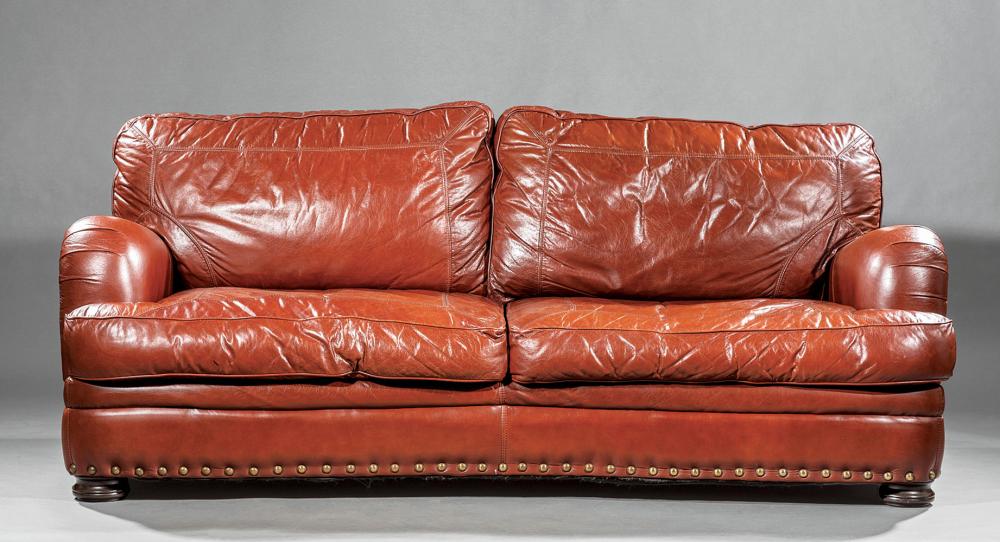 Appraisal: Brown Leather Sofa loose back and seat cushions rolled arms