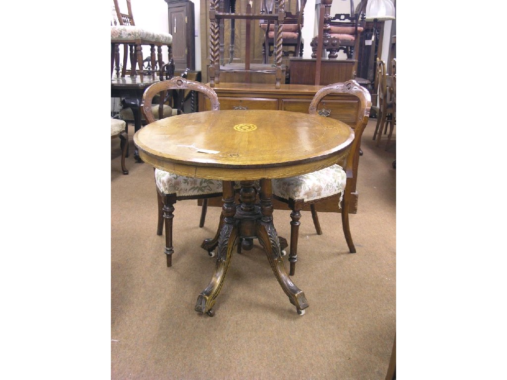 Appraisal: A Victorian inlaid walnut breakfast table oval top tilting upon