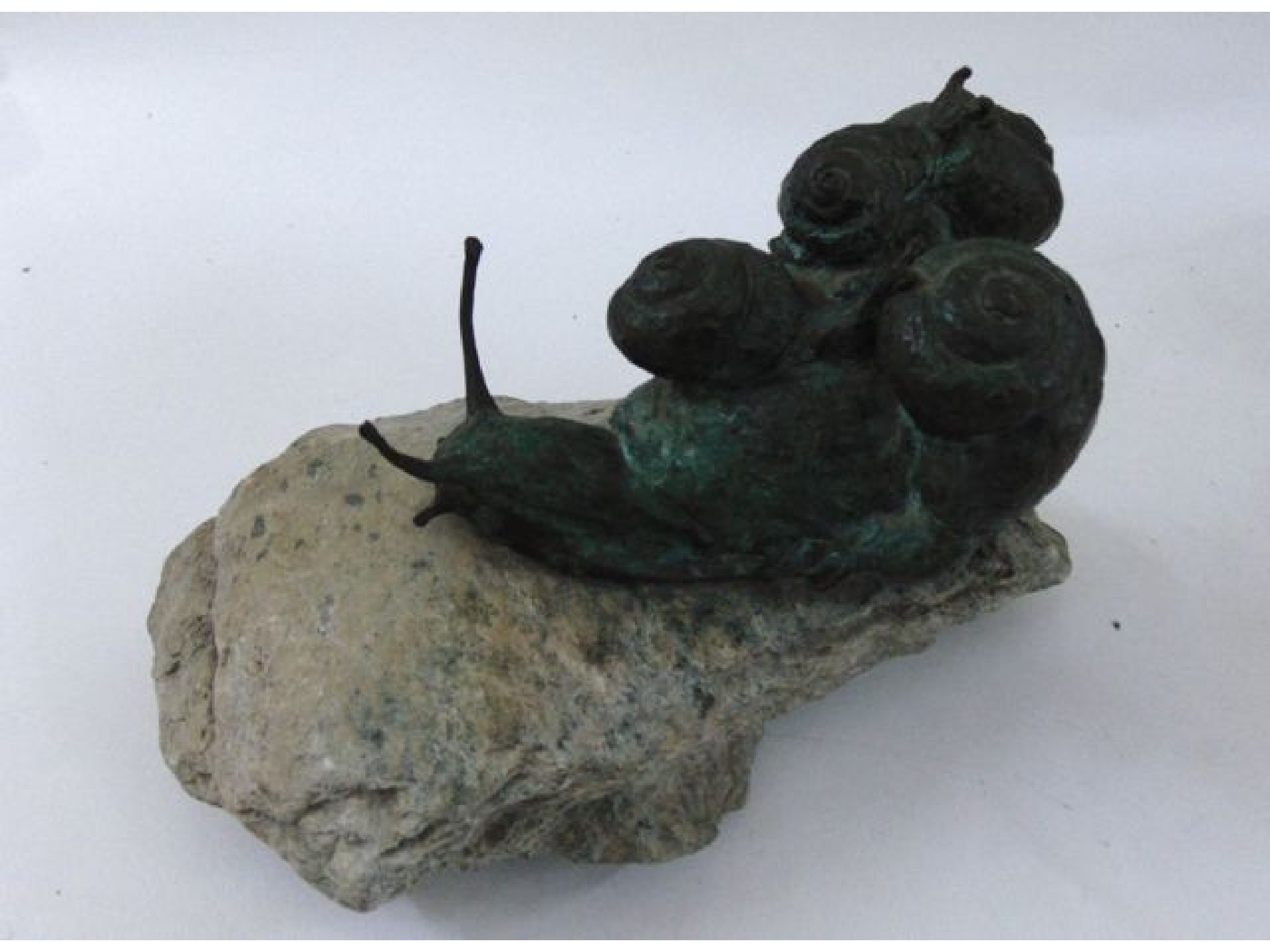 Appraisal: A bronze group of five snails on a natural rock