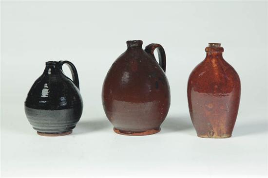 Appraisal: THREE REDWARE BOTTLES AND FLASKS American mid th century Two