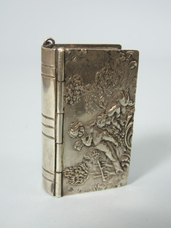 Appraisal: A Continental silver Vesta Case formed as a book embossed