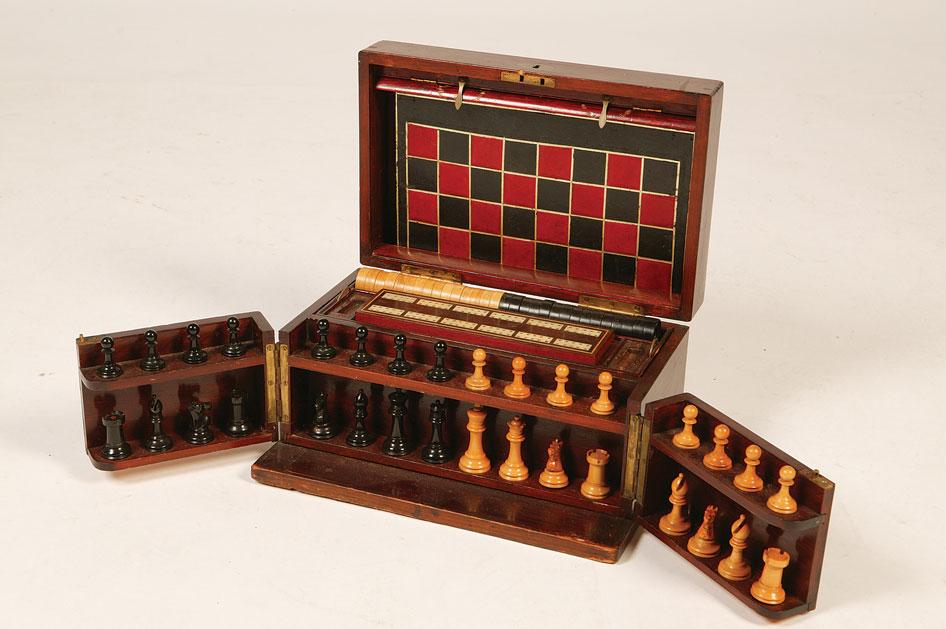 Appraisal: A CASED GAMES COMPENDIUM containing chessmen draughts pieces a cribbage