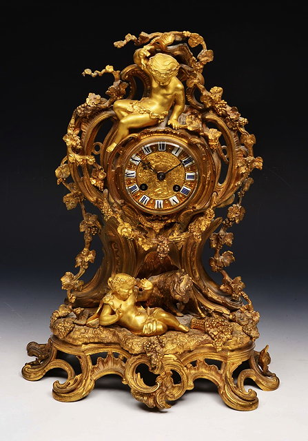 Appraisal: A TH CENTURY FRENCH ORMOLU MANTEL CLOCK the circular dial